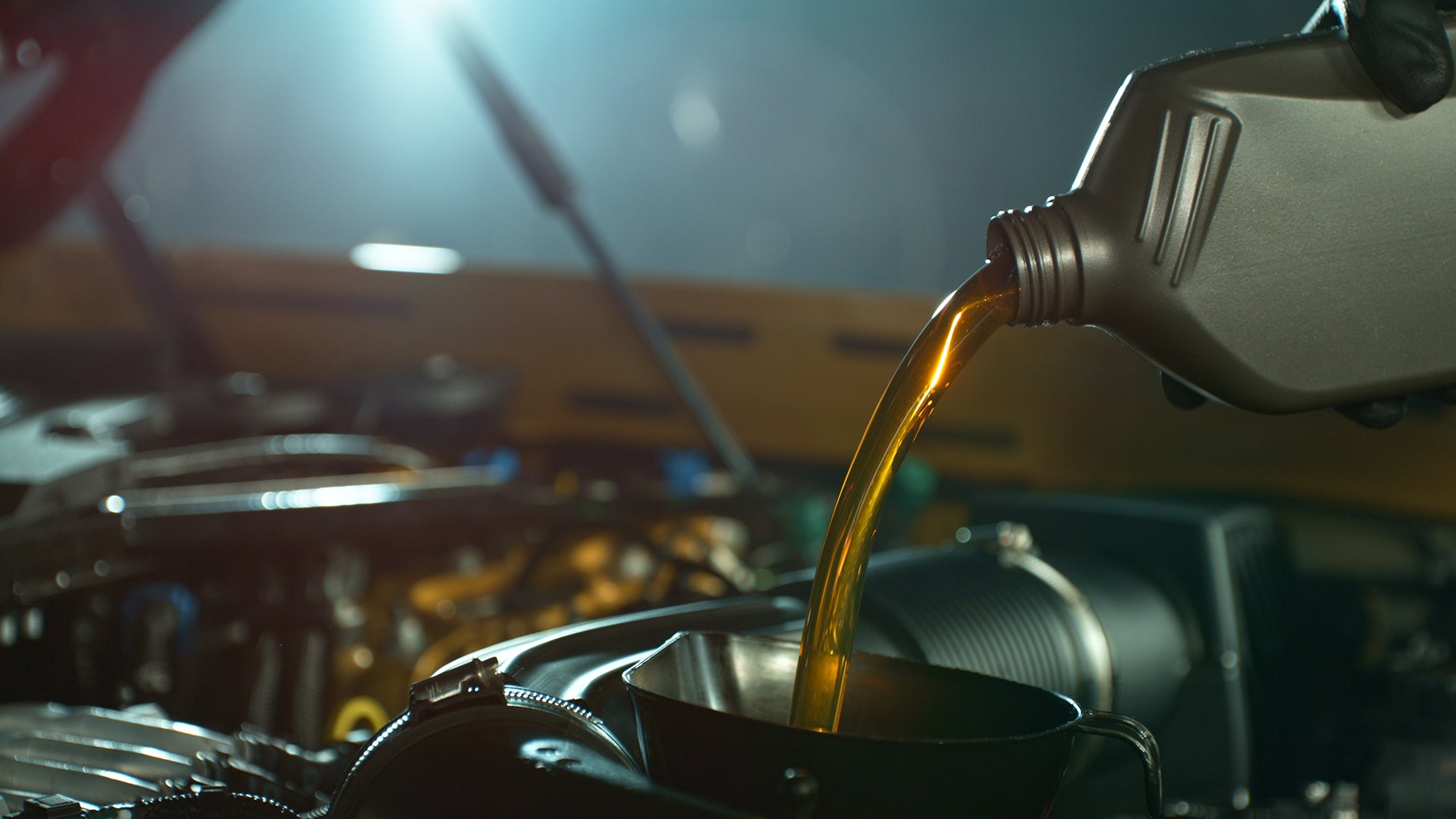 Factory-trained technician performing a Volkswagen Golf oil change at Mike Reichenbach Volkswagen